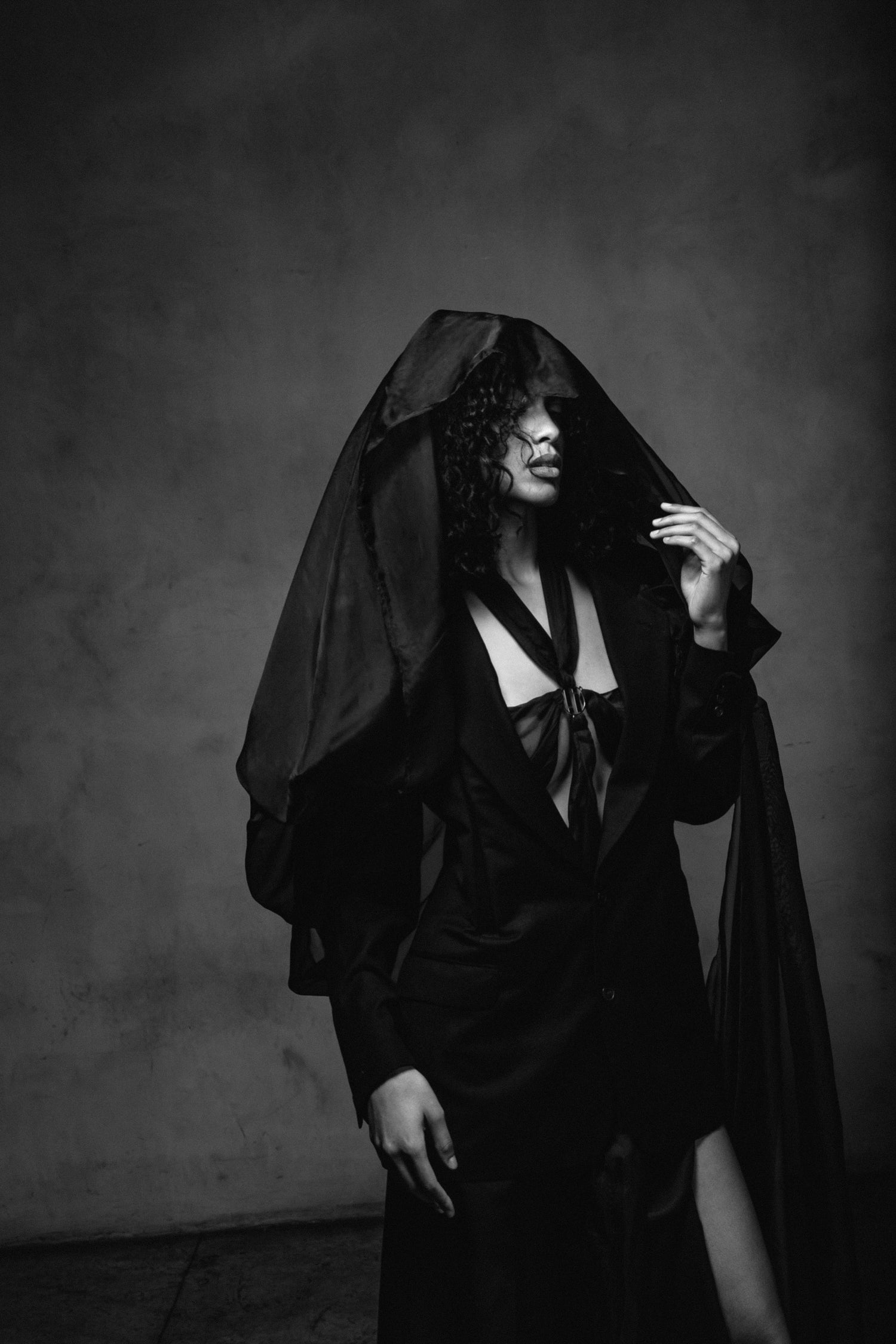 Model wearing all-black look from Corii Burns Santé Mentale Collection in a black and white photo, featured on the Contact page.