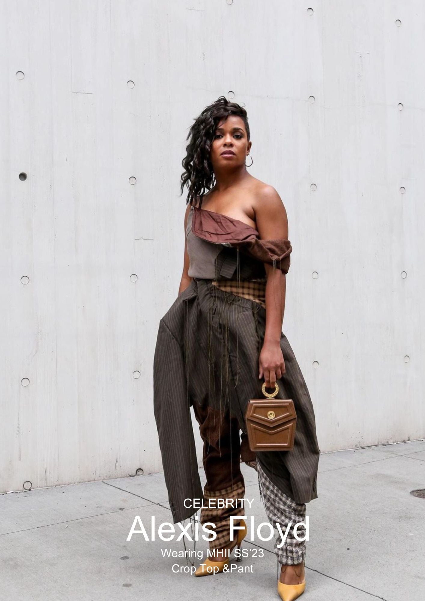 Actress Alexis Floyd wearing Corii Burns MHII Collection brown crop top with deconstructed blazer and baggy pants at New York Fashion Week